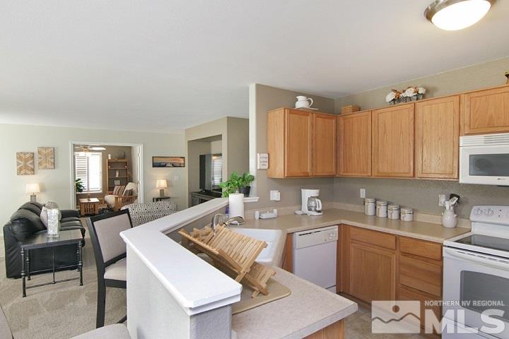 7724 Tulear Street Reno, NV 89506 - Photo 3 of 23 a kitchen with a table chairs sink and cabinets