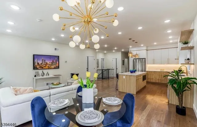 a dining room with furniture and a potted plant