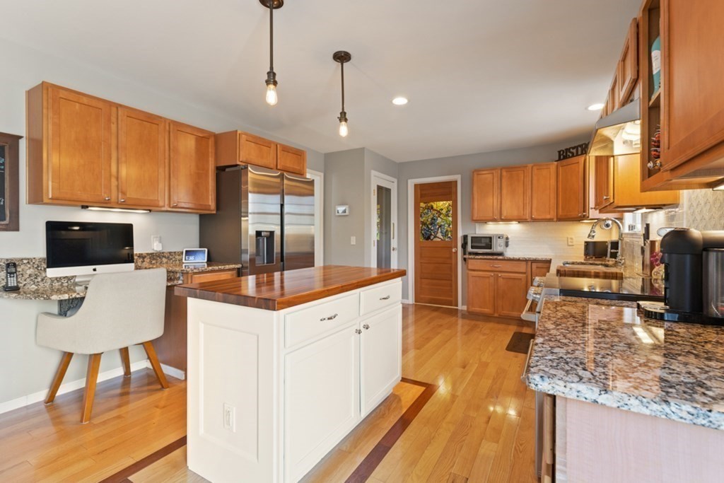 82 Hammersmith Drive Saugus, MA 01906 - Photo 18 of 41 a kitchen with granite countertop a counter top space a sink stainless steel appliances and cabinets