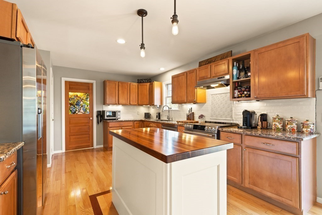 82 Hammersmith Drive Saugus, MA 01906 - Photo 19 of 41 a kitchen with granite countertop stainless steel appliances a sink a counter space and cabinets