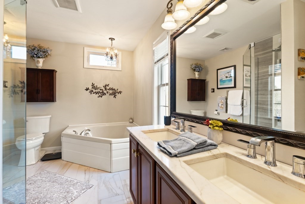 82 Hammersmith Drive Saugus, MA 01906 - Photo 28 of 41 a bathroom with a tub sink and mirror