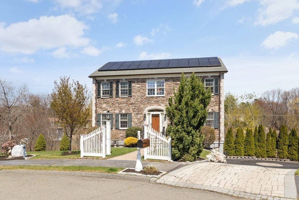 82 Hammersmith Drive Saugus, MA 01906 - Photo 4 of 41 a front view of a house with a garden and pathway