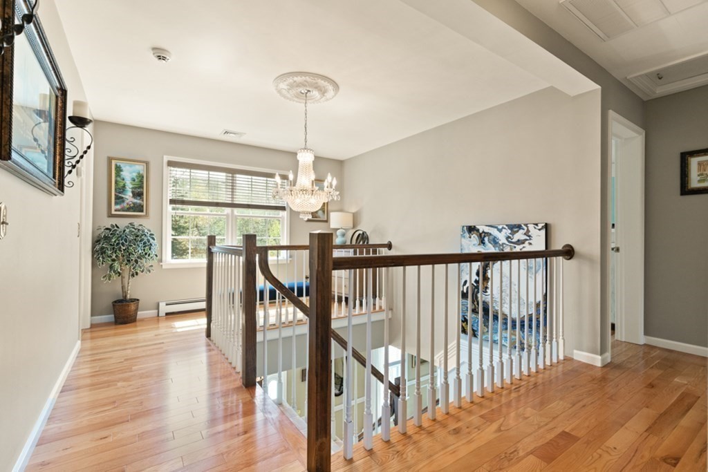 82 Hammersmith Drive Saugus, MA 01906 - Photo 10 of 41 a view of a hallway with wooden floor and stairs
