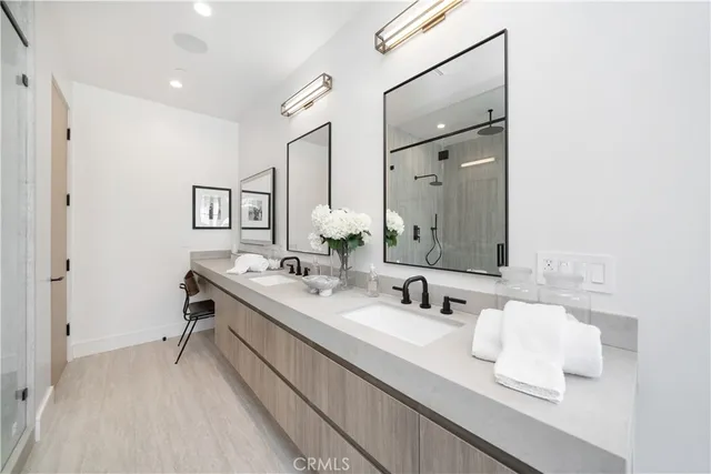 a bathroom with a sink double vanity and a mirror