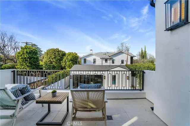 a view of a chair and table in the balcony