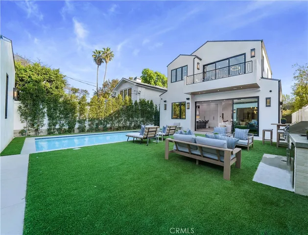 a view of a house with a yard and sitting area