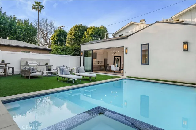 a view of a house with backyard and sitting area