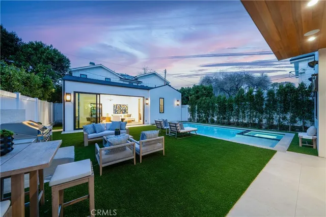 a view of a house with backyard sitting area and garden