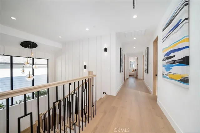 a view of a hallway with furniture and a window