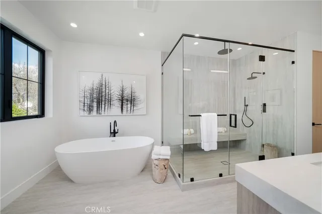 a bathroom with a bathtub and shower