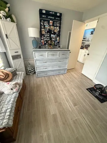 a bathroom with a granite countertop sink toilet a mirror a vanity and shower