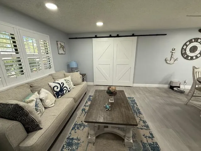 a kitchen with stainless steel appliances a stove a sink and white cabinets