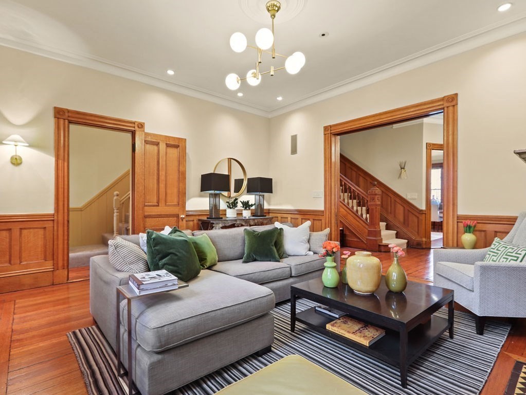 a living room with furniture and a chandelier