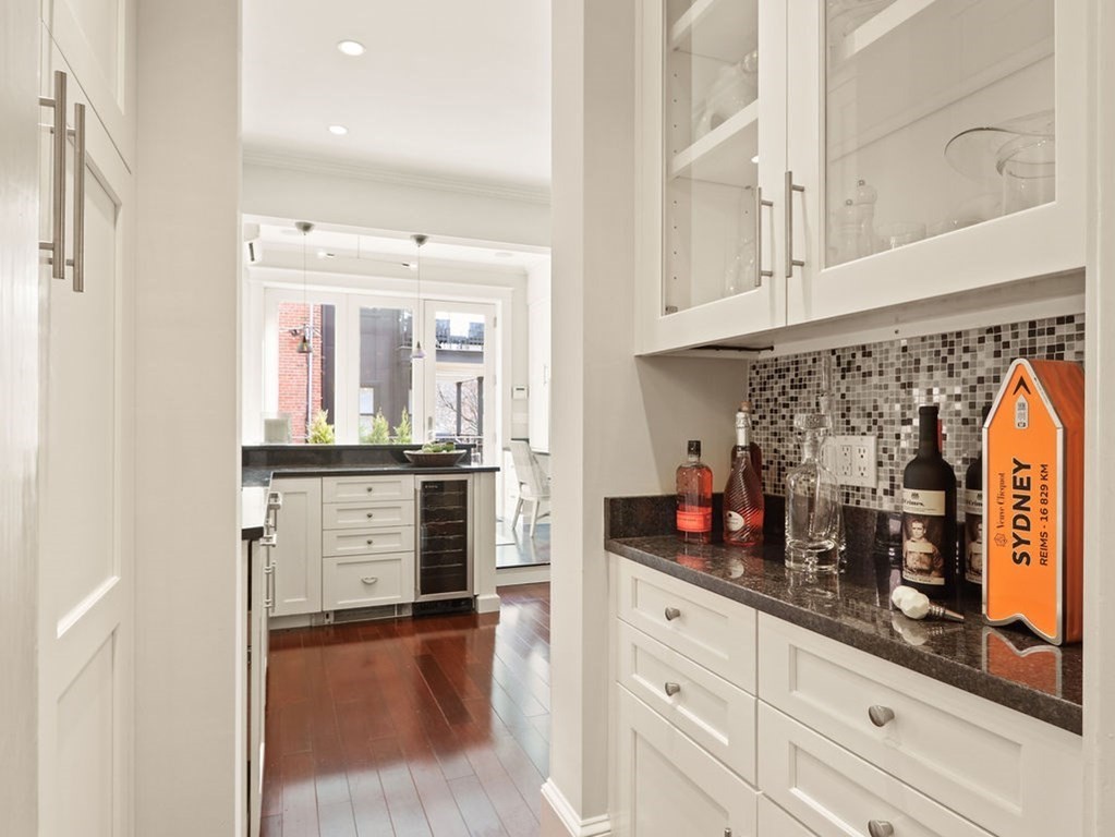138 St Botolph Street Boston, MA 02115 - Photo 11 of 39 a kitchen with white cabinets and window