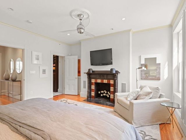 a living room with furniture a fireplace and a flat screen tv