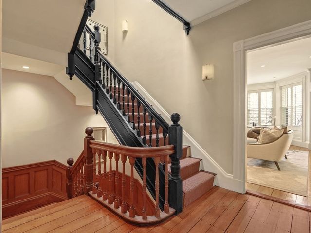 a view of entryway and hall with wooden floor