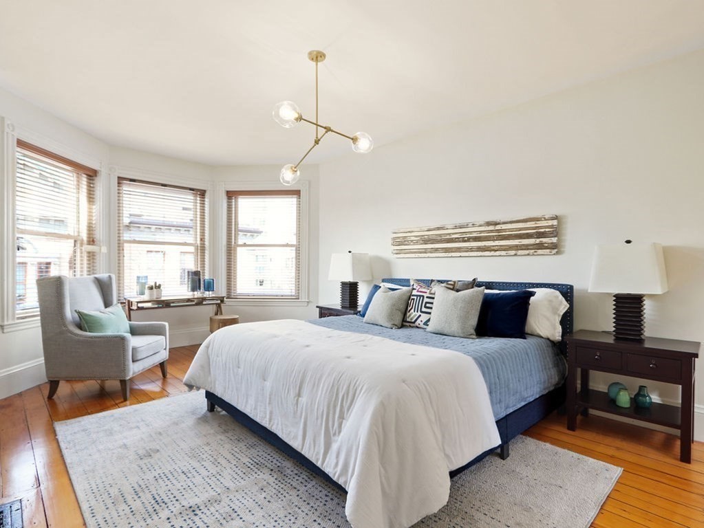 138 St Botolph Street Boston, MA 02115 - Photo 24 of 39 a bedroom with a bed a couch and large windows