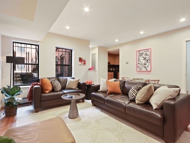 a living room with furniture or couch and a potted plant