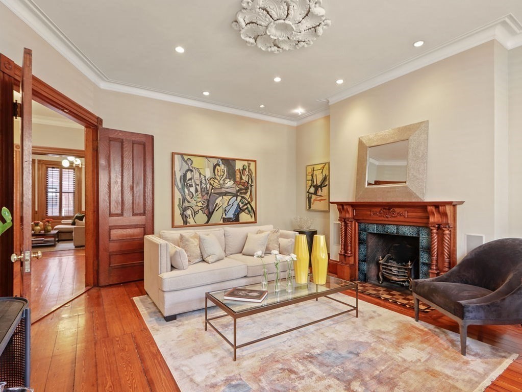 138 St Botolph Street Boston, MA 02115 - Photo 3 of 39 a living room with furniture and a fireplace