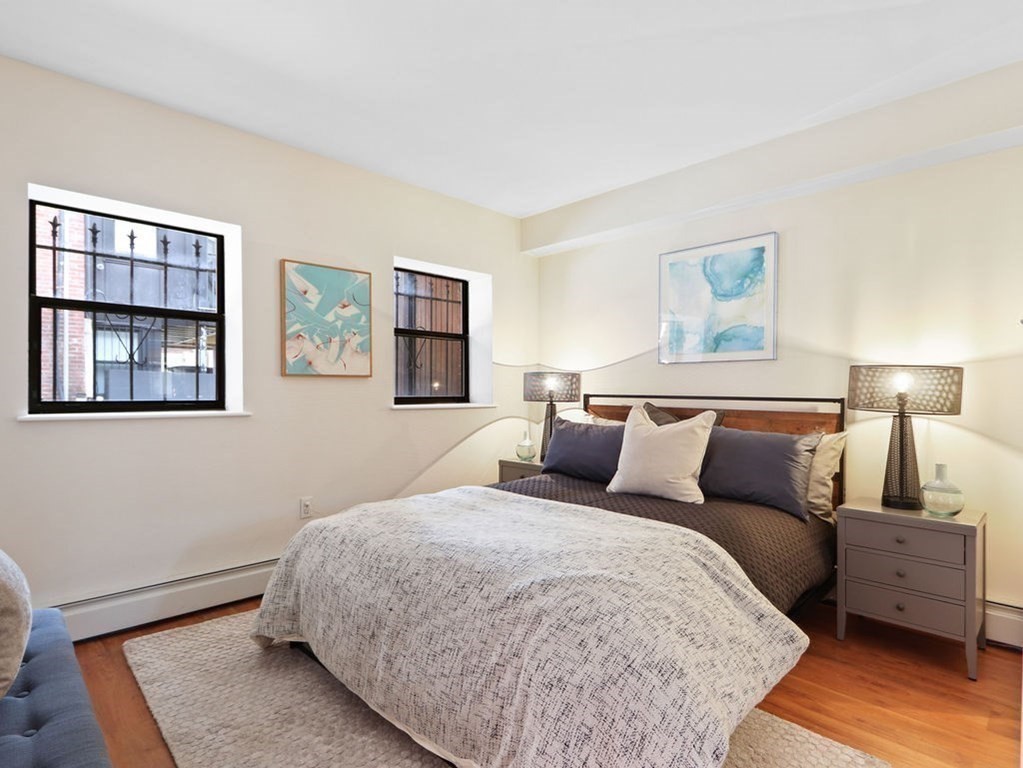 138 St Botolph Street Boston, MA 02115 - Photo 31 of 39 a bedroom with a bed and a painting on the wall
