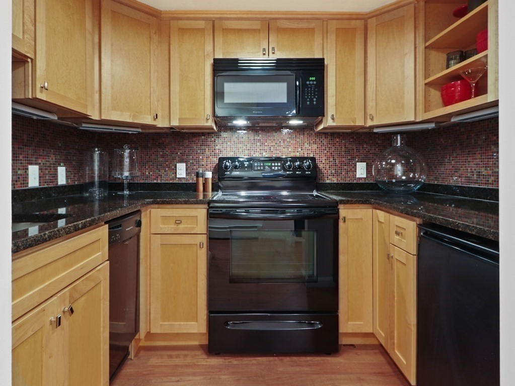 138 St Botolph Street Boston, MA 02115 - Photo 32 of 39 a kitchen with stainless steel appliances granite countertop a stove and a microwave