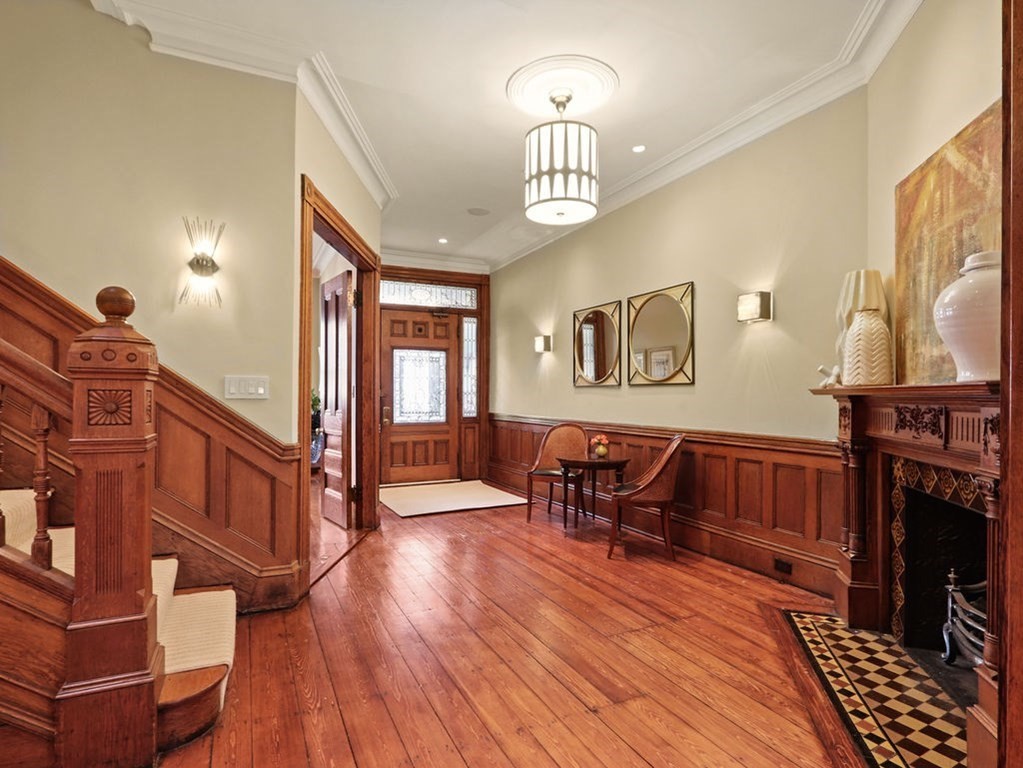 138 St Botolph Street Boston, MA 02115 - Photo 5 of 39 a living room with furniture a dining table and a fireplace