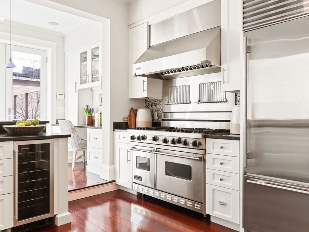 138 St Botolph Street Boston, MA 02115 - Photo 7 of 39 a kitchen with a stove and white cabinets