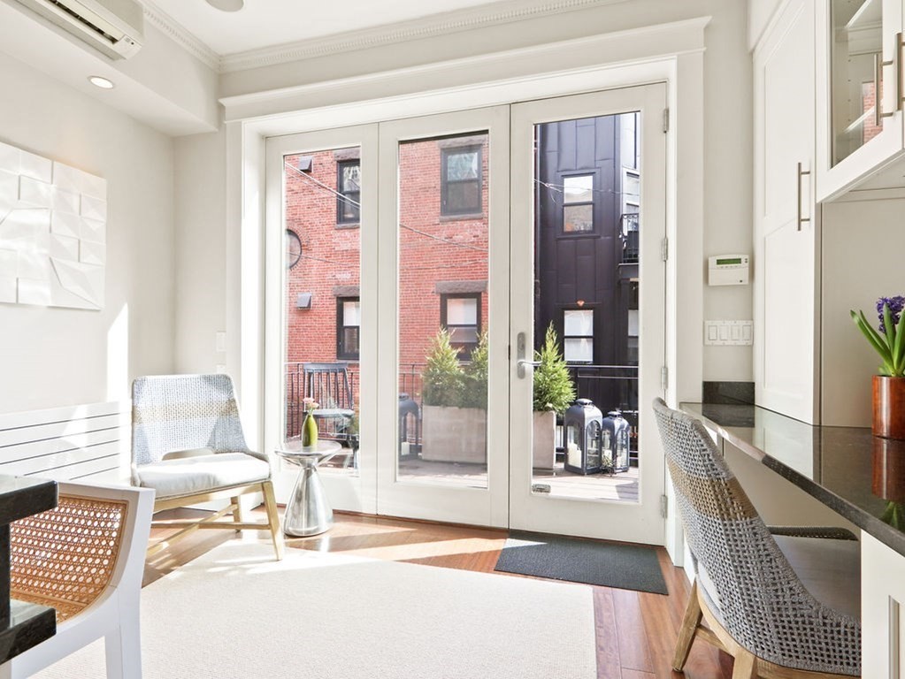 138 St Botolph Street Boston, MA 02115 - Photo 9 of 39 a living room with furniture and large windows