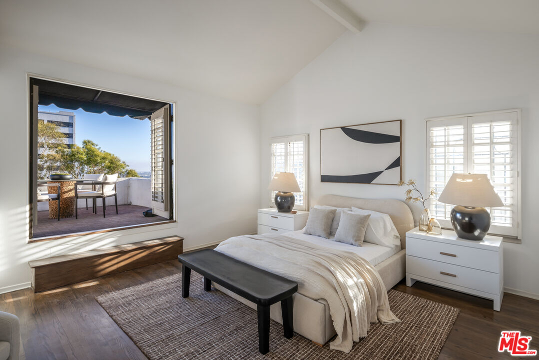 8420 Cresthill Road Los Angeles, CA 90069 - Photo 11 of 30 a bedroom with a bed and wooden floor