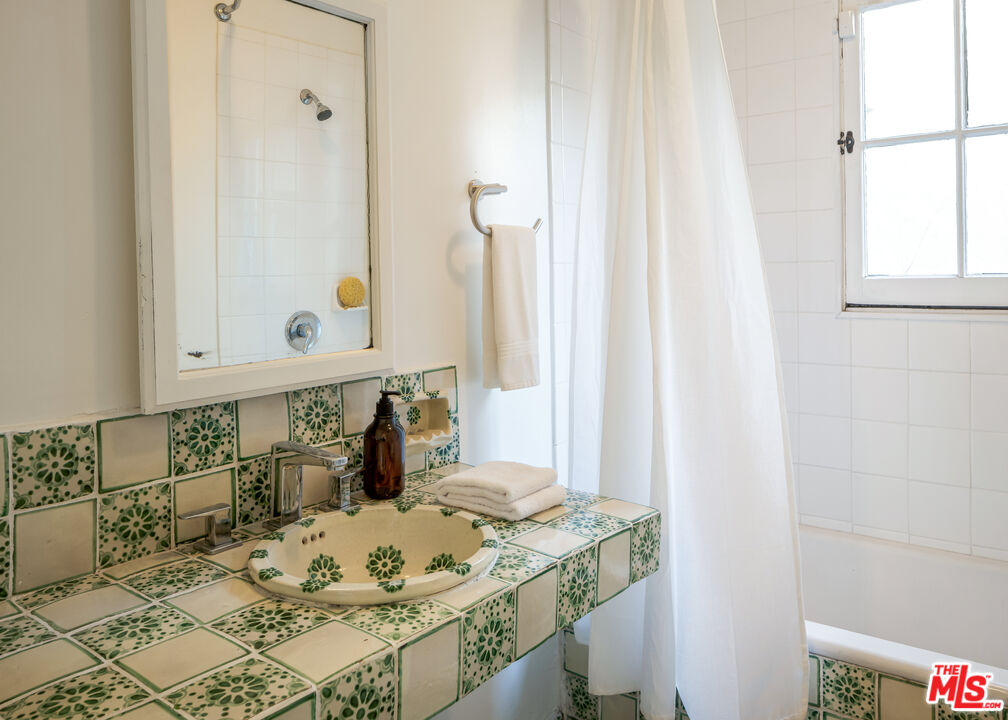 8420 Cresthill Road Los Angeles, CA 90069 - Photo 21 of 30 a bathroom with a sink and a mirror