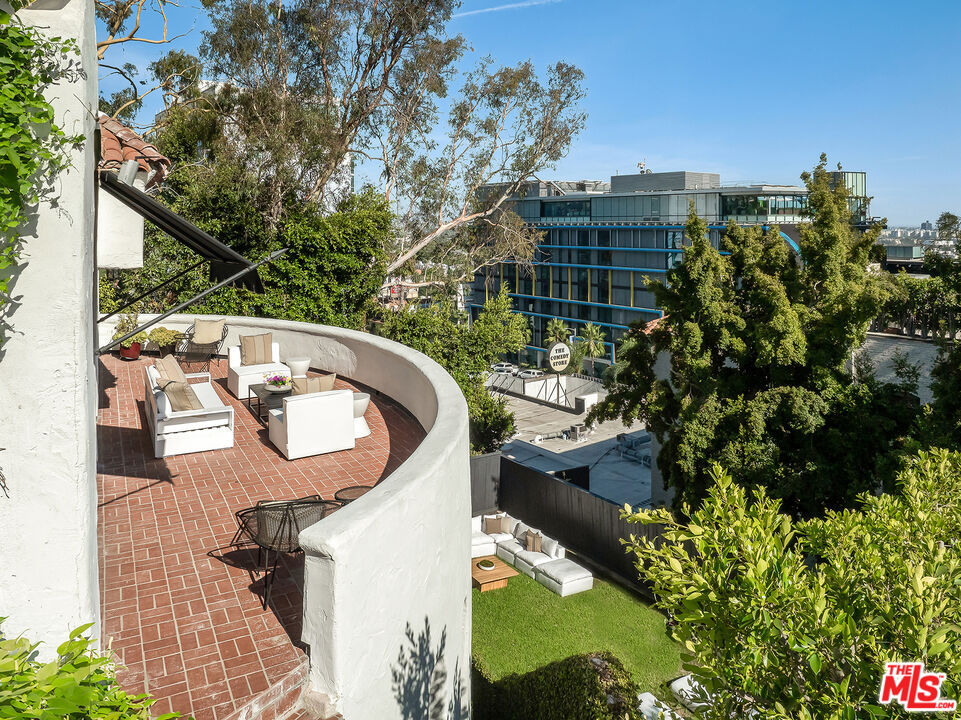 8420 Cresthill Road Los Angeles, CA 90069 - Photo 22 of 30 a view of a swimming pool with a patio and a yard