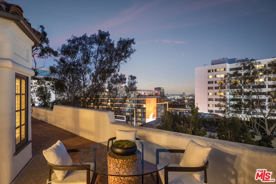 8420 Cresthill Road Los Angeles, CA 90069 - Photo 27 of 30 a view of balcony with table and chairs