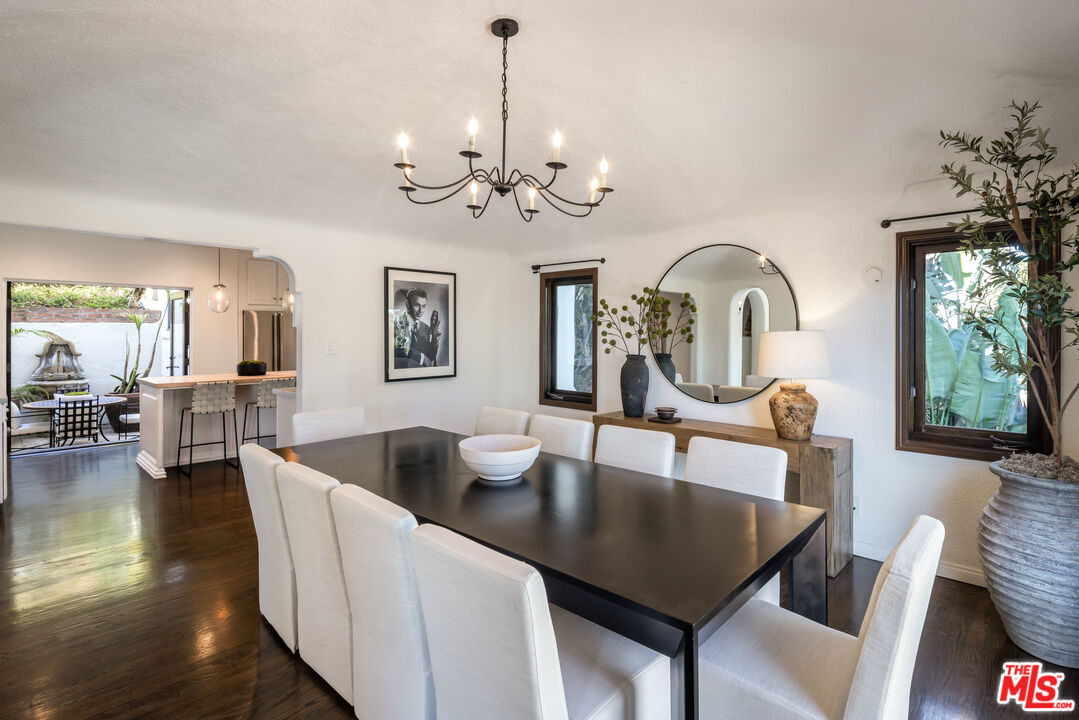 8420 Cresthill Road Los Angeles, CA 90069 - Photo 8 of 30 a view of a dining room with furniture a chandelier and wooden floor