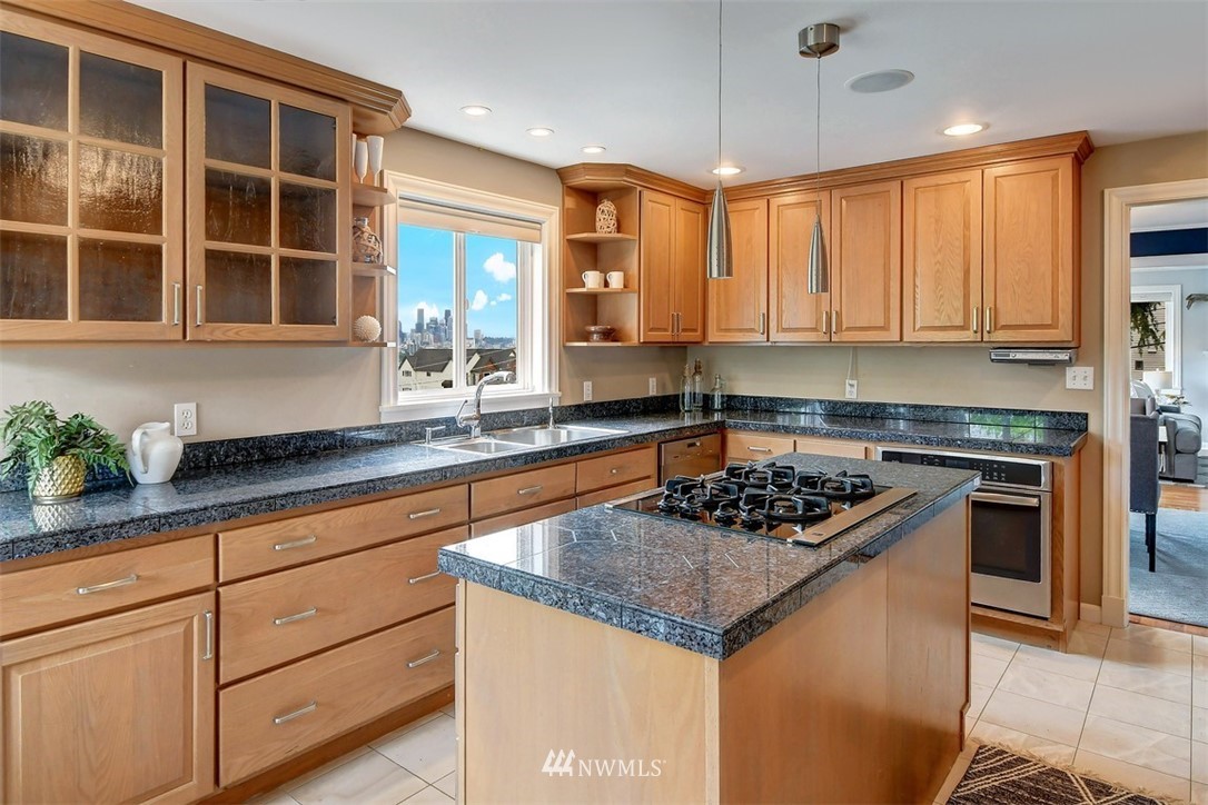 2004 26th Avenue West Seattle, WA 98199 - Photo 11 of 36 a kitchen with stainless steel appliances granite countertop a sink and a stove