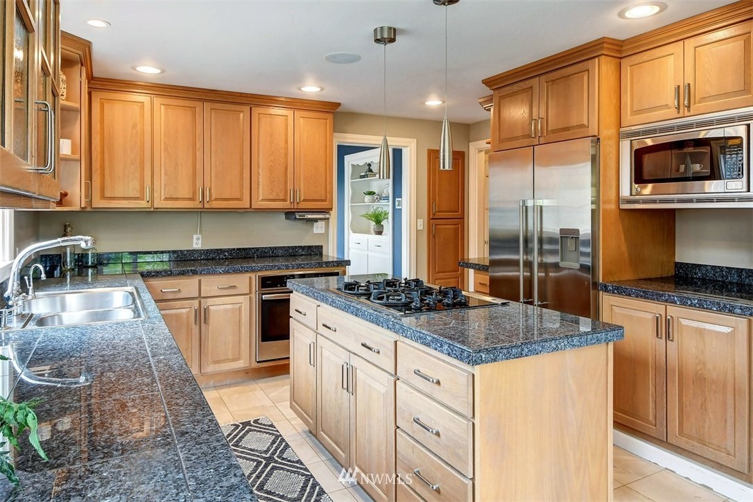 2004 26th Avenue West Seattle, WA 98199 - Photo 12 of 36 a kitchen with stainless steel appliances granite countertop a stove a sink and a microwave