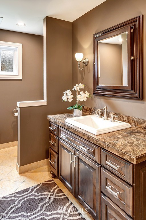 2004 26th Avenue West Seattle, WA 98199 - Photo 13 of 36 a bathroom with a granite countertop sink and a mirror