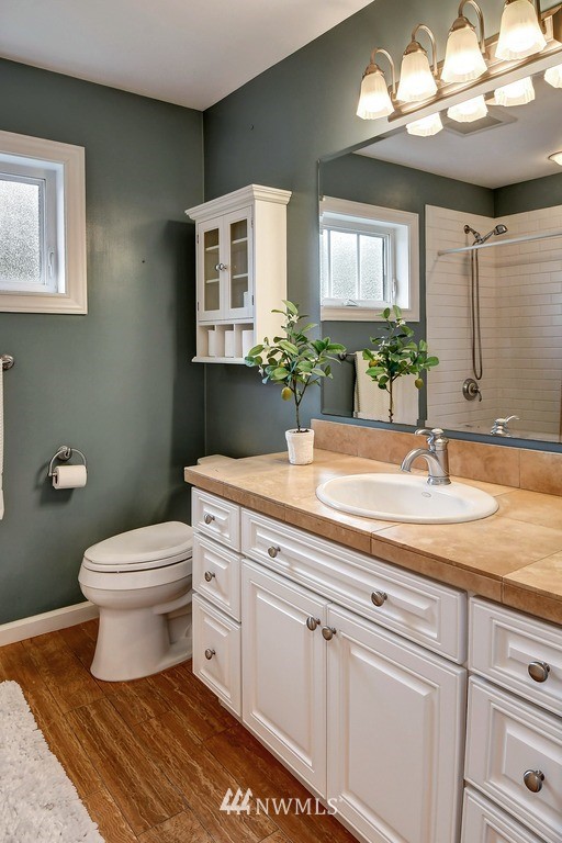 2004 26th Avenue West Seattle, WA 98199 - Photo 24 of 36 a bathroom with a toilet sink and mirror