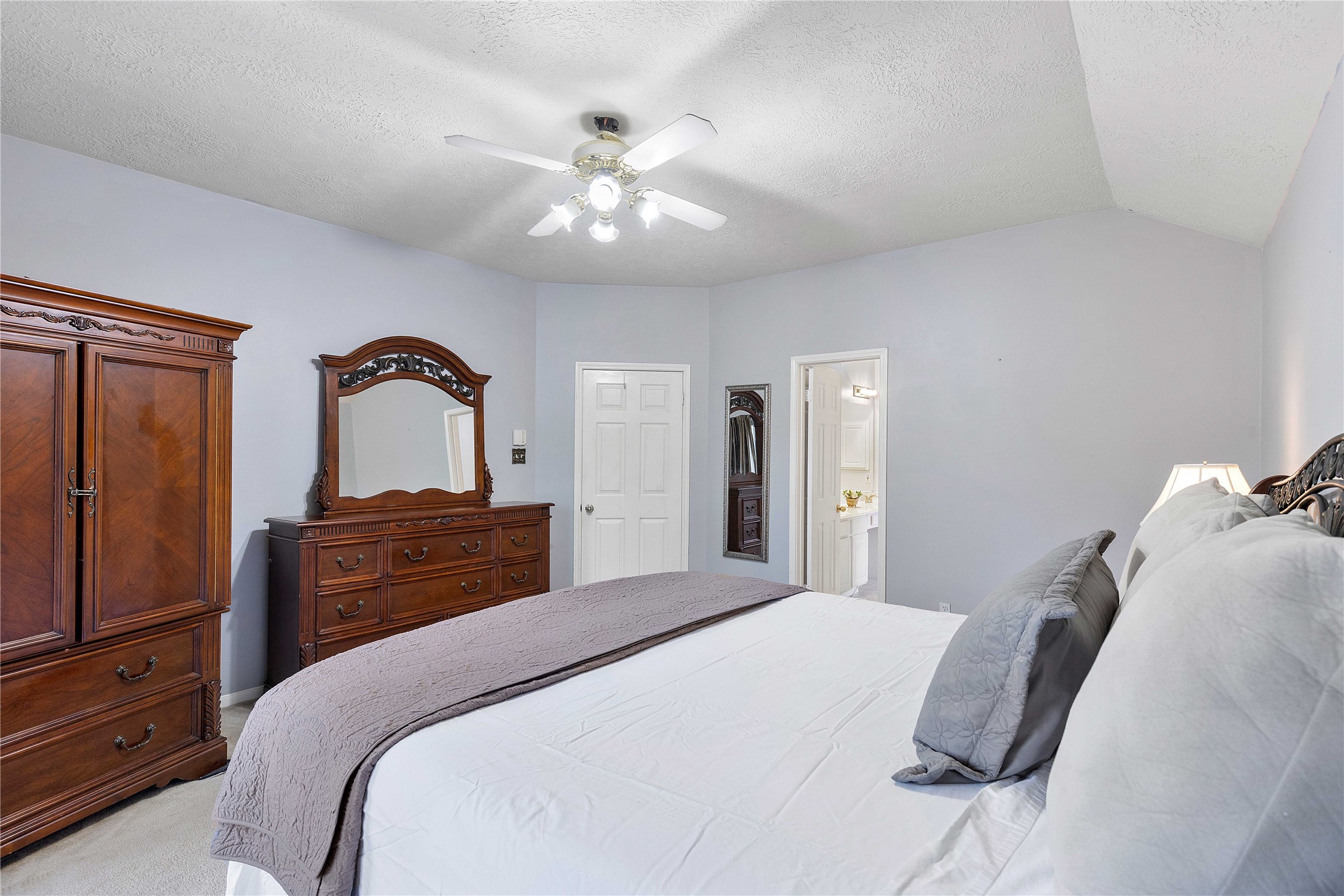 1707 Moston Drive Spring, TX 77386 - Photo 24 of 41 a bedroom with a large bed and a chandelier