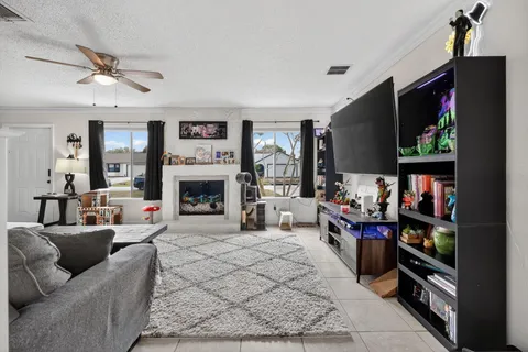 a living room with fireplace furniture and a flat screen tv