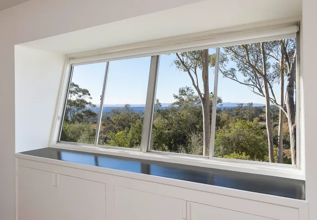a view of a room that has a large window
