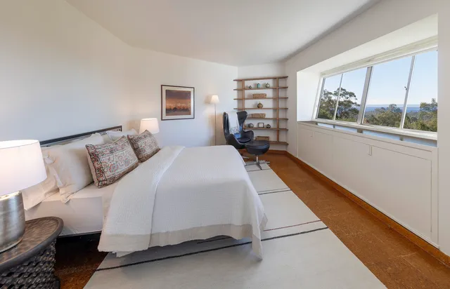 a bed room with a bed and a large window