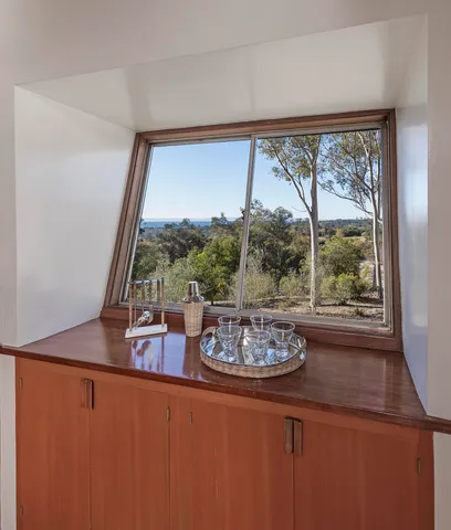 a view of a room with a floor to ceiling window and an outdoor view