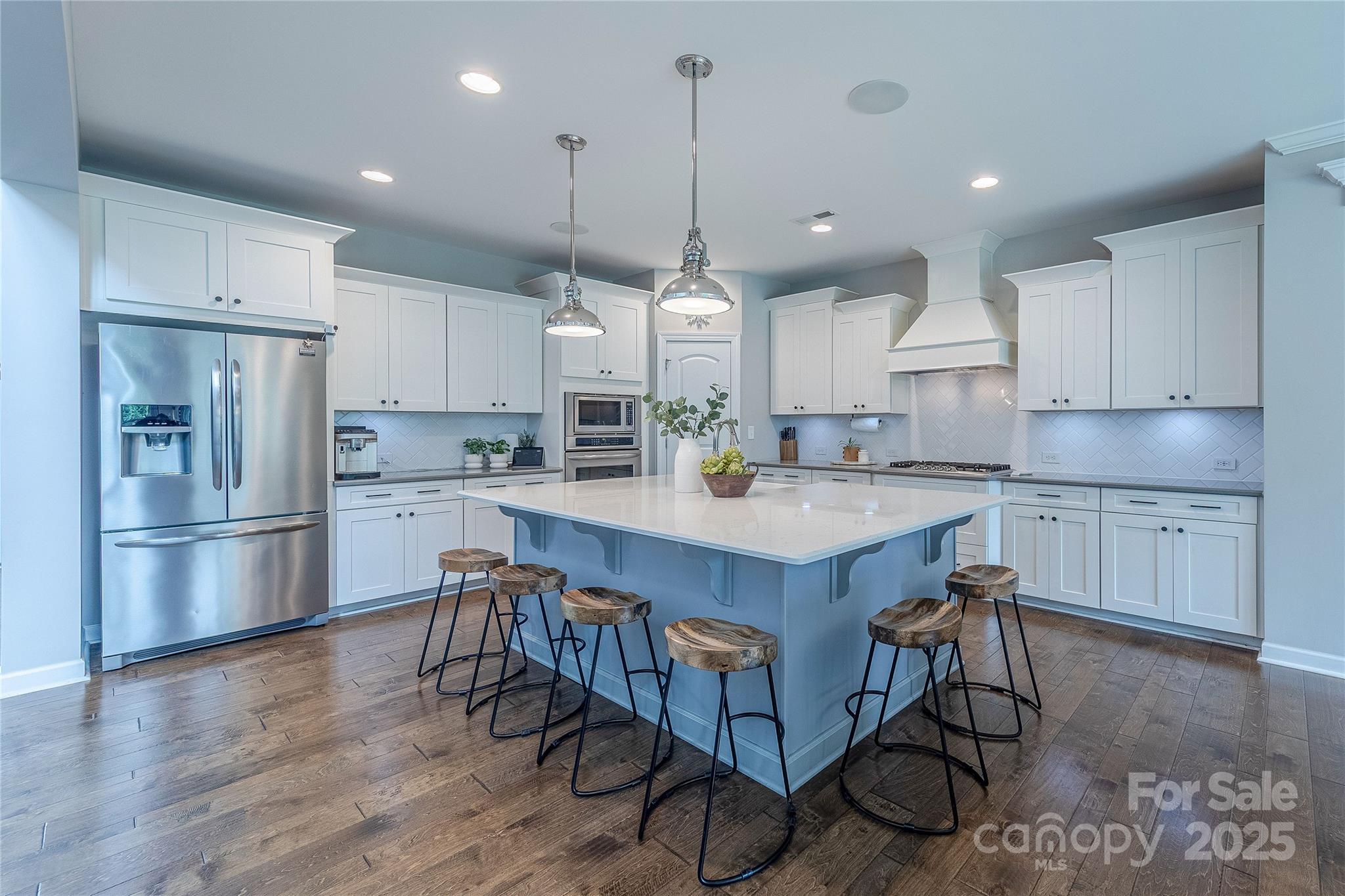 240 Hampton Trail Drive Fort Mill, SC 29708 - Photo 10 of 47 a kitchen with stainless steel appliances granite countertop a table chairs refrigerator and microwave