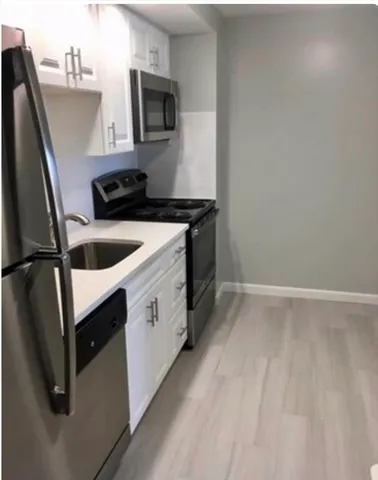 a kitchen that has a sink and a microwave
