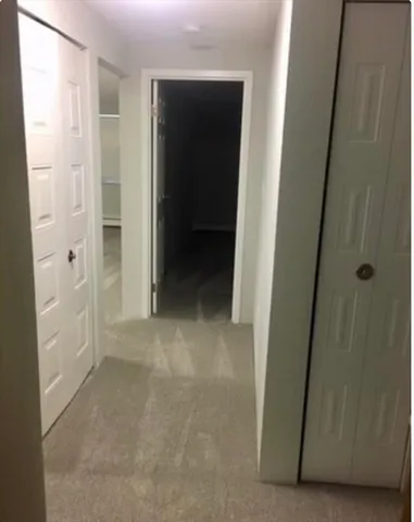 a view of a hallway to rooms