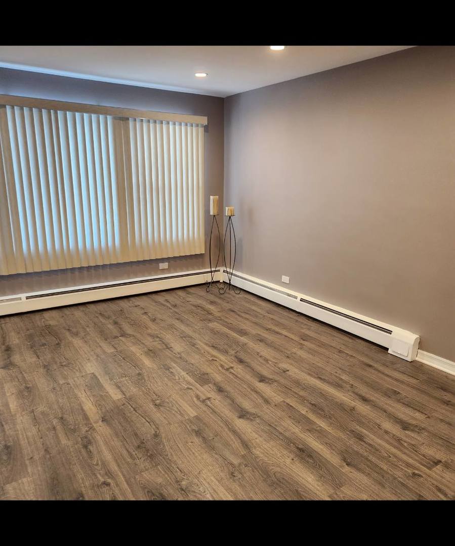 720 North Western Avenue, Unit 10 Park Ridge, IL 60068 - Photo 3 of 19 a view of an empty room with wooden floor