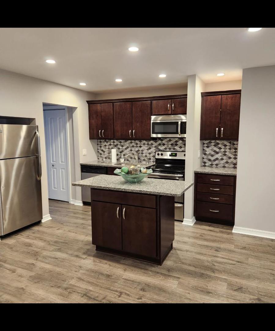 720 North Western Avenue, Unit 10 Park Ridge, IL 60068 - Photo 5 of 19 a kitchen with stainless steel appliances granite countertop a refrigerator a sink a stove and a microwave
