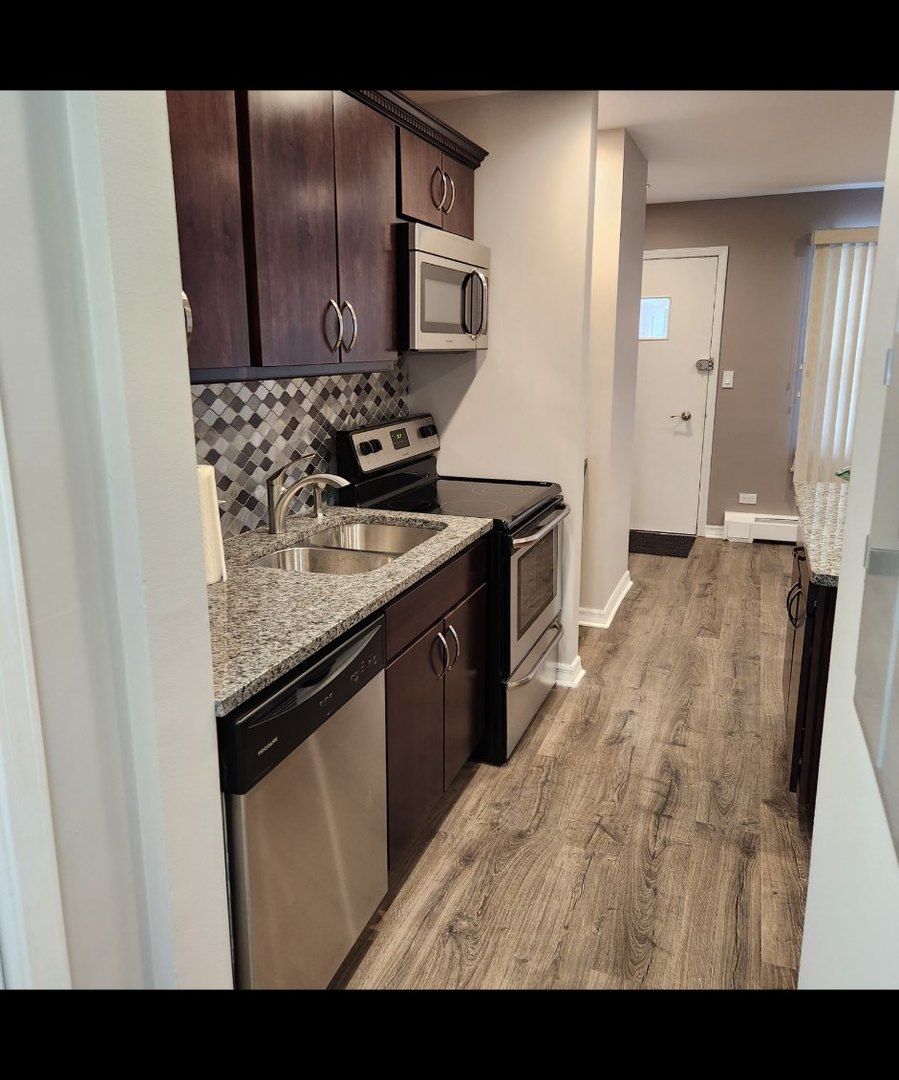 720 North Western Avenue, Unit 10 Park Ridge, IL 60068 - Photo 8 of 19 a kitchen with stainless steel appliances granite countertop a stove a sink and a refrigerator