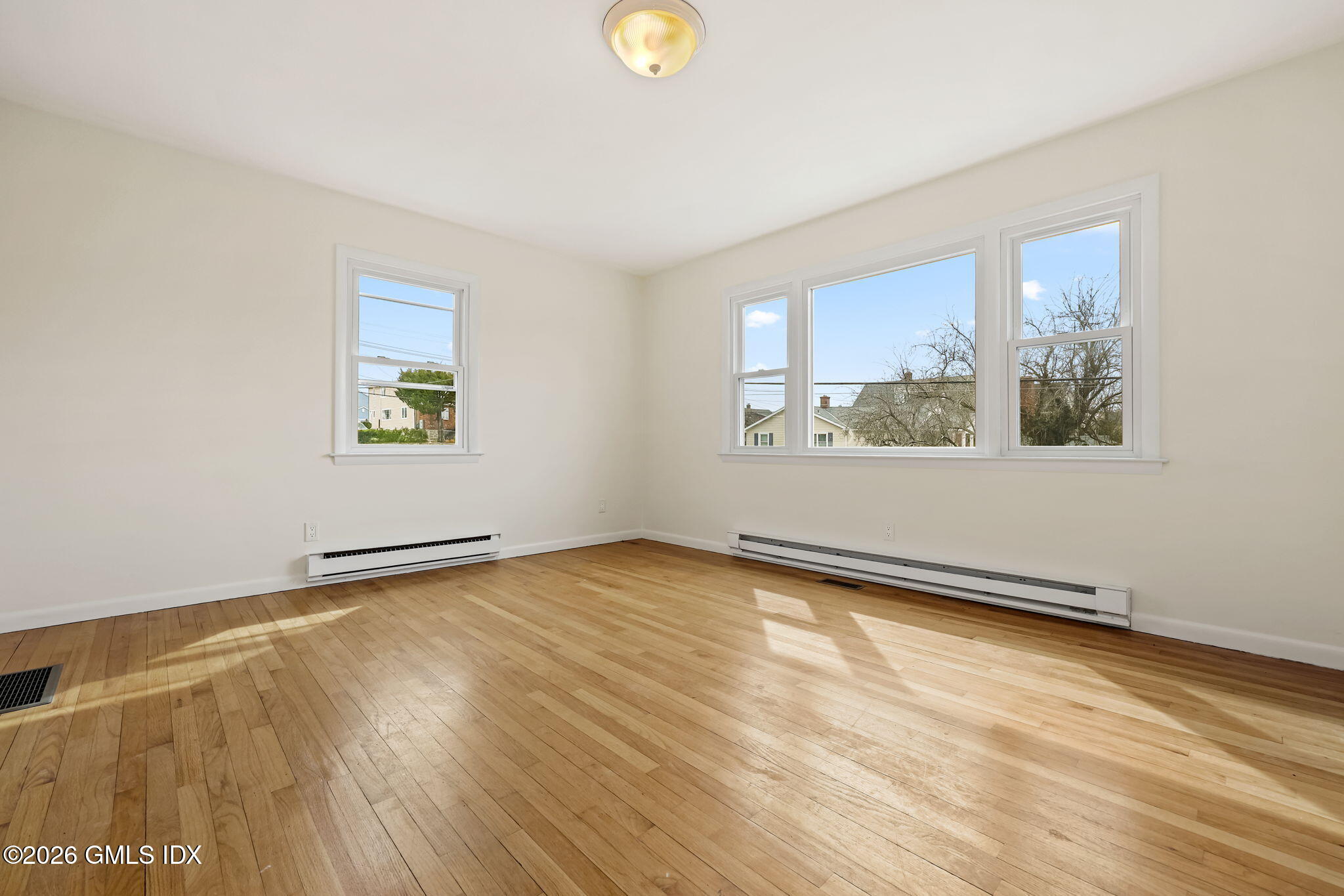 2 Grange Street, Unit 1 Greenwich, CT 06830 - Photo 3 of 11 a view of an empty room with a window and wooden floor