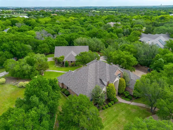 an aerial view of a house with yard and outdoor seating